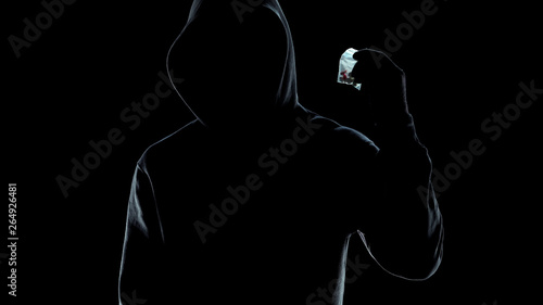 Male silhouette holding packet with pills, drug trafficking crime, lifestyle © motortion
