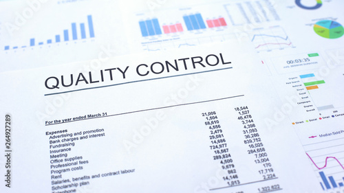 Quality control official document lying on table, graphs charts and diagrams