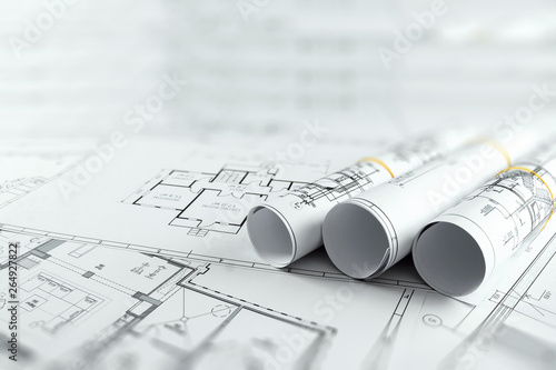 Architectural construction drawings twisted into a roll, construction projects on paper. The concept of architecture, construction, engineering. Copy space.