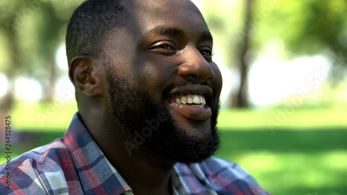 Smiling african american bearded man relaxing outdoors, enjoying life, happiness