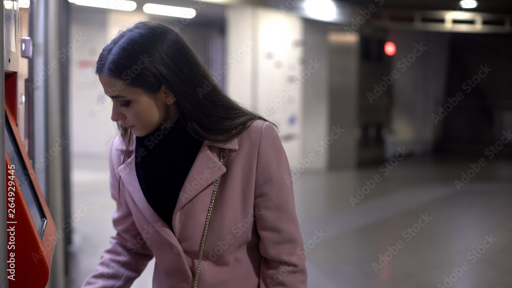 Wealthy woman withdrawing money in ATM at night time, finance, crime risk Wealthy woman withdrawing money in ATM at night time, finance, crime risk