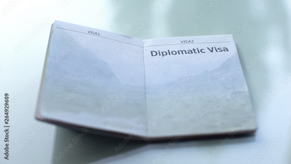 Diplomatic visa, opened passport lying on table in customs office, travelling Diplomatic visa, opened passport lying on table in customs office, travelling