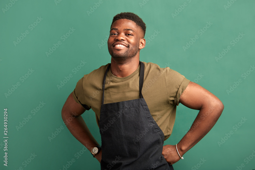 Ταπετσαρία African male farmer with muscular hands and sportive body, dressed in apron smil