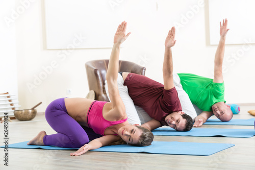 Flexible people practicing yoga