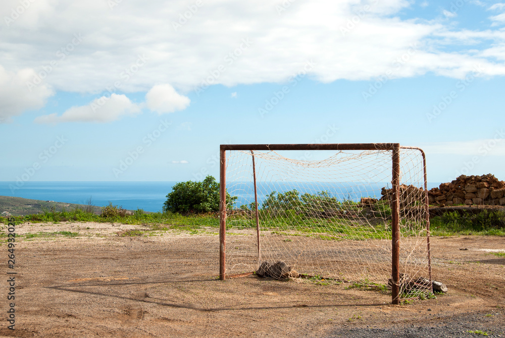 Abandoned football field with an old goal in rural environment above sea on the island of Tenerife, Spain, Europe. Abandoned football field with an old goal in rural environment above sea on the island of Tenerife, Spain, Europe.