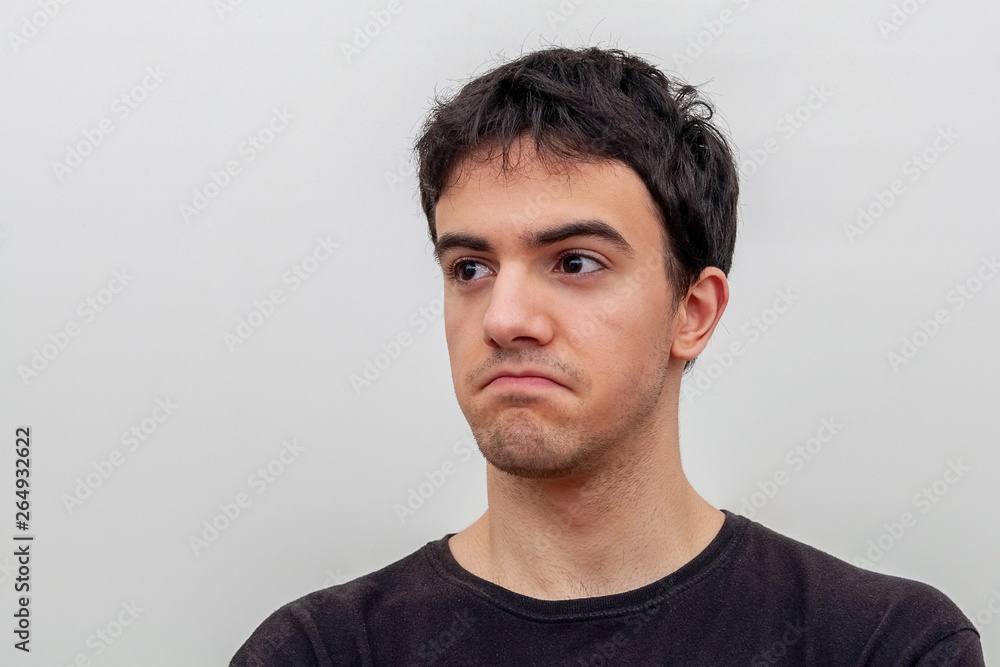 Fototapeta premium portrait of a frustrated young guy on white background