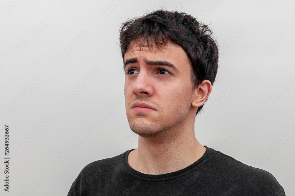 Fototapeta premium portrait of a sad young guy on white background