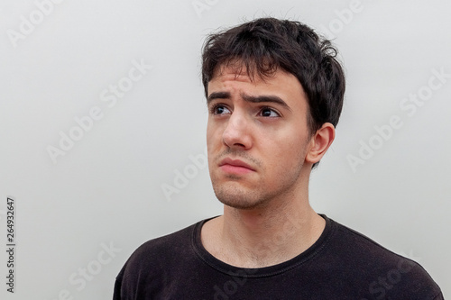 portrait of a sad young guy on white background