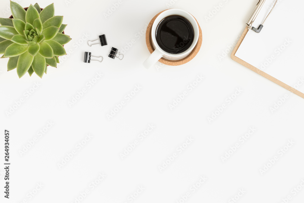 Workspace accessories, coffee and a succulent plant on a white table.  Flat lay with blank copy space.