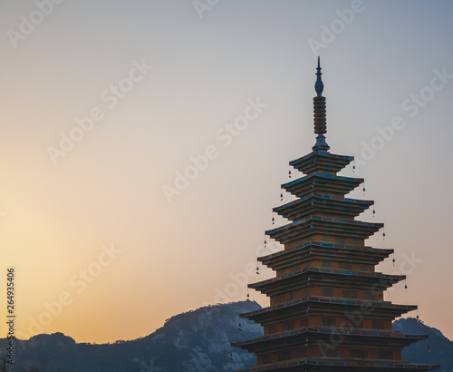 Classic Korean pagoda against the backdrop of mountains and sunset  a trip to Seoul and South Korea
