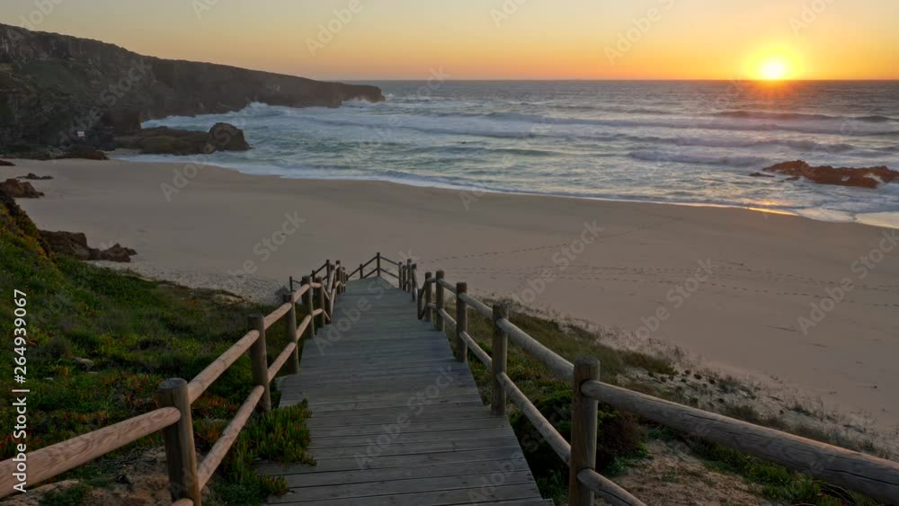Walking down the stairs to the beach during sunset. Atlantic ocean coast of Portugal. UHD Walking down the stairs to the beach during sunset. Atlantic ocean coast of Portugal. UHD