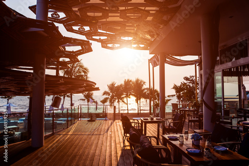 Beautiful tropical beach restaurant with palm trees. Sunrises and sunsets. Ocean.