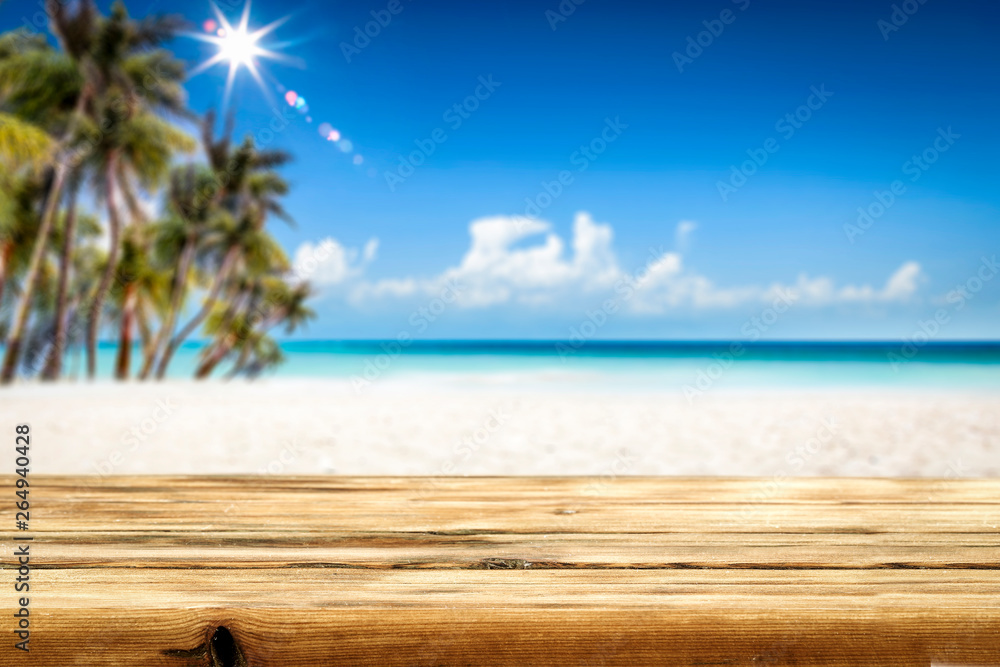 Summer table background of free space for your decoration and landscape of beach with palms. 