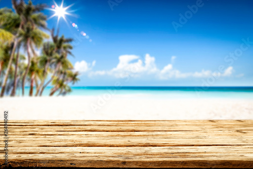 Fototapeta Naklejka Na Ścianę i Meble -  Summer table background of free space for your decoration and landscape of beach with palms. 