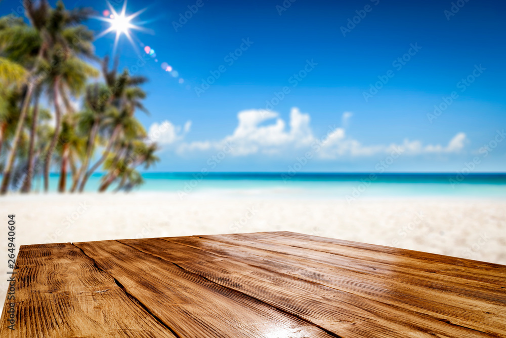 Summer table background of free space for your decoration and landscape of beach with palms. 