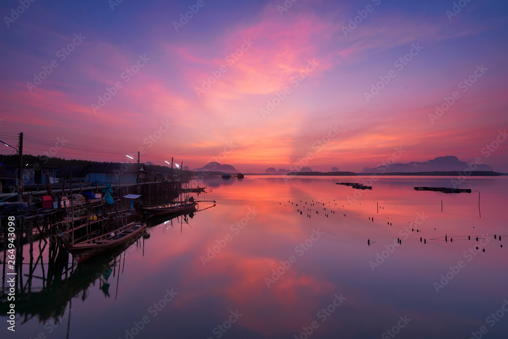 Beautiful sky at fsherman village during sunrise and fisherman longtail boats