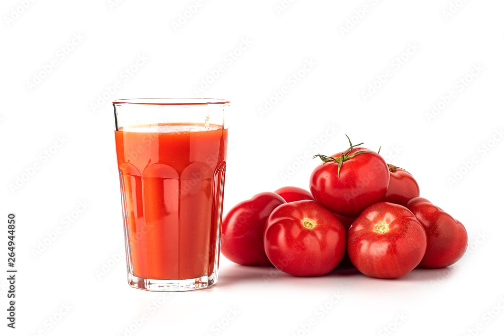 Tomato juice in a glass, with tomatoes on a white background Tomato juice in a glass, with tomatoes on a white background