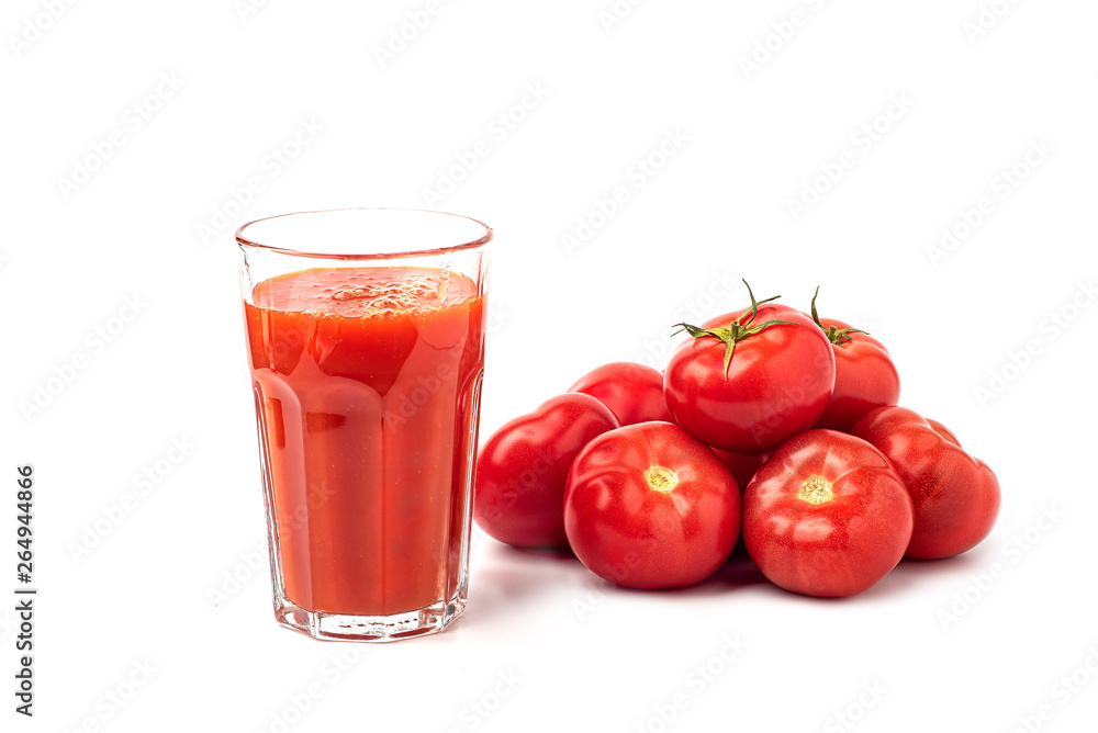 Tomato juice in a glass, with tomatoes on a white background Tomato juice in a glass, with tomatoes on a white background