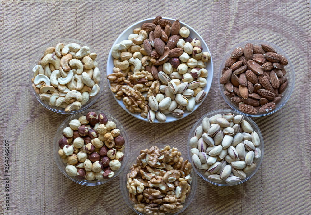 Healthy food. Nuts mix assortment on texture top view. Collection of different legumes for background image close up nuts, pistachios, almond, cashew nuts, peanut, walnut. image