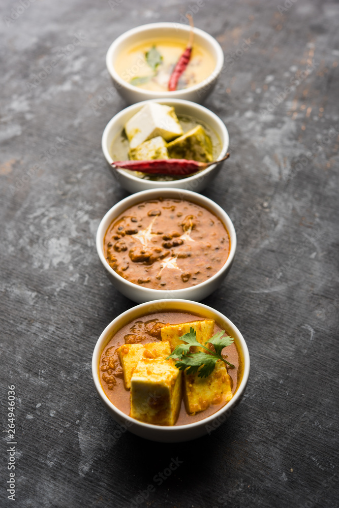 Palak paneer butter masala, yellow dal or dal-makhani served in a bowl in a group. selective focus Palak paneer butter masala, yellow dal or dal-makhani served in a bowl in a group. selective focus