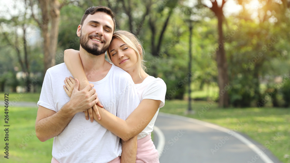 young couple people are in love. hugging in the park during summer season (friendship or valentine concept) young couple people are in love. hugging in the park during summer season (friendship or valentine concept)