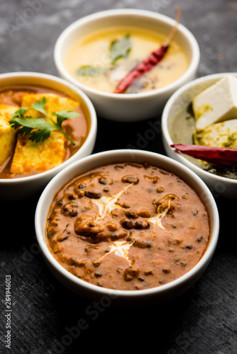 Palak paneer butter masala, yellow dal or dal-makhani served in a bowl in a group. selective focus