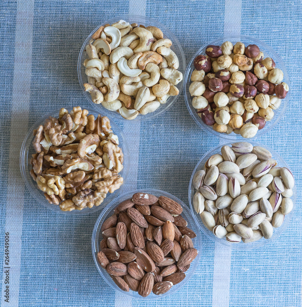 Healthy food. Nuts mix assortment on stone texture top view. Collection of different legumes for background image close up nuts, pistachios, almond, cashew nuts, peanut, walnut. image Healthy food. Nuts mix assortment on stone texture top view. Collection of different legumes for background image close up nuts, pistachios, almond, cashew nuts, peanut, walnut. image