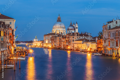 Classic panoramic view of famous Canal Grande with scenic Basilica di Santa Maria della Salute in beautiful golden evening light at sunset with retro vintage filter effect, Venice, Italy