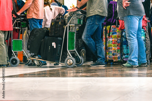 Passengers waiting in line for boarding an airport for a flight, travelers queue at check-in, returning from vacation to the worst days, congested airports in tilt, stress and fatigue