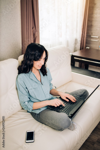 Bbeautiful woman using laptop computer at home on sofa photo