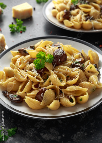 Conchiglie pasta with mushrooms, creamy sauce, parmesan cheese and herbs