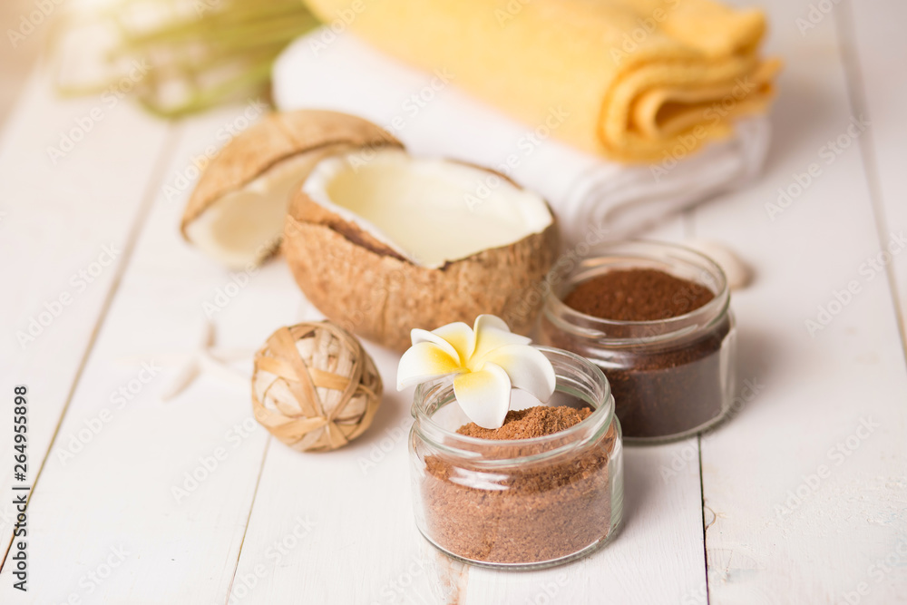Coconut, spa products, coffee scrub and seashells on white background Coconut, spa products, coffee scrub and seashells on white background
