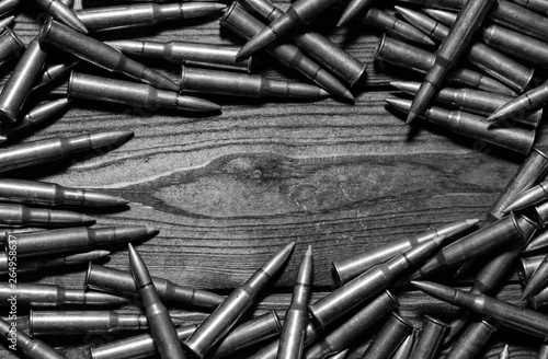 Bullets on wooden background.