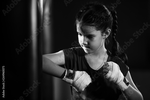 The female child in the boxing glove near the old punch bag The concept of martial arts and myself