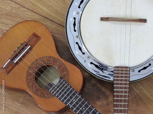 Close-up of two Brazilian string musical instruments: cavaquinho and samba banjo on a wooden surface. They are widely used to accompany samba, the most famous Brazilian rhythm.