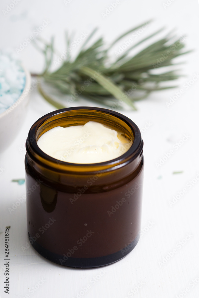 shea butter in brown glass pot and lavender leaves shea butter in brown glass pot and lavender leaves