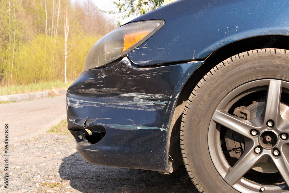 Fototapeta premium Damaged car. Broken front bumper. The concept of road safety. Close up.