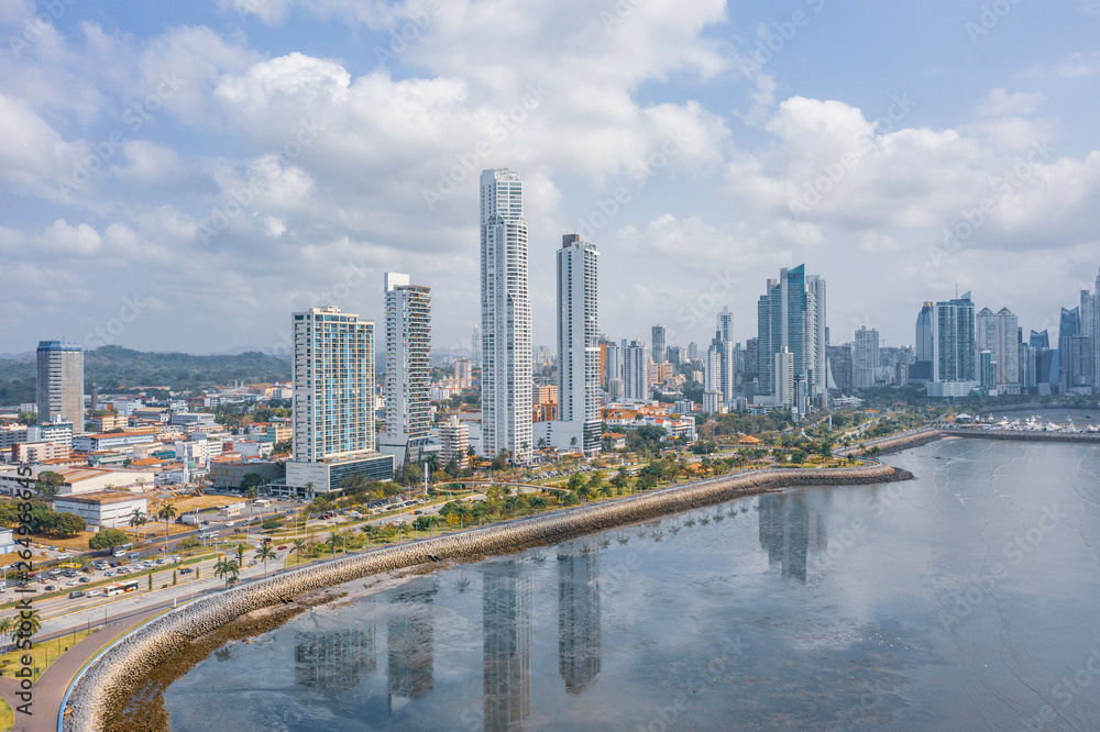 Scenic aerial view of downtown of capital of Panama. Beautiful cloudy look of skyscrapers on coastline of Pacific ocean in Panama-City. Shot of hightech megapolis in small country in Caribbean sea 