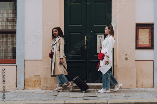 Two beautiful young women walking on the street
