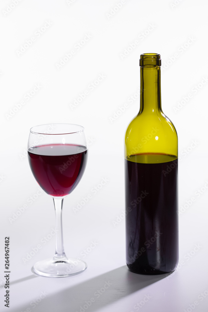 Bottle and glass with red wine on white background Bottle and glass with red wine on white background