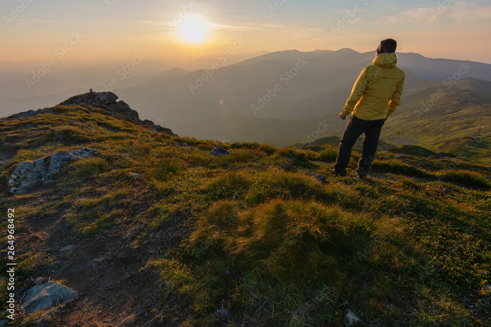 Warm summer season in the Ukrainian Carpathians with view of the observatory White elephant and tourist with a tent against the background of the mountains