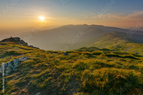 Warm summer season in the Ukrainian Carpathians with view of the observatory White elephant and tourist with a tent against the background of the mountains © reme80