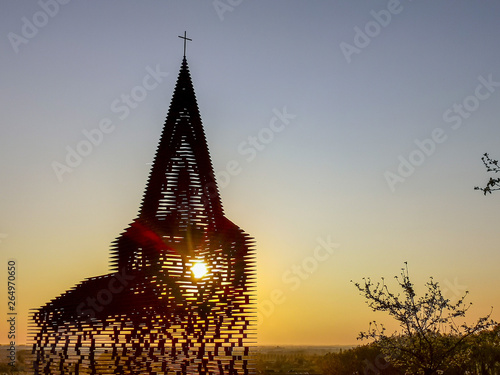 Steel see-through church in Borgloon (Hesbaye, Belgium), known as the art project Reading between the lines, during sunset photo