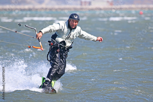 Kitesurfer riding his board toeside