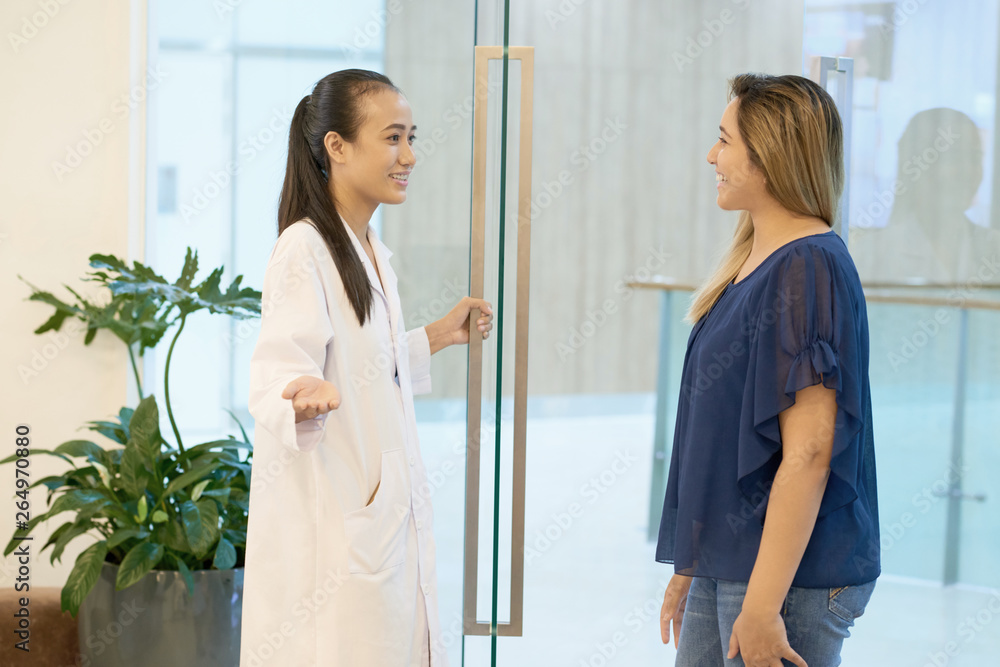 Doctor meeting patient in clinic entrance Doctor meeting patient in clinic entrance