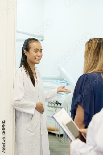 Dentist welcoming patient