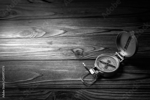 tourist compass on wooden background. tourism, outdoor activities.