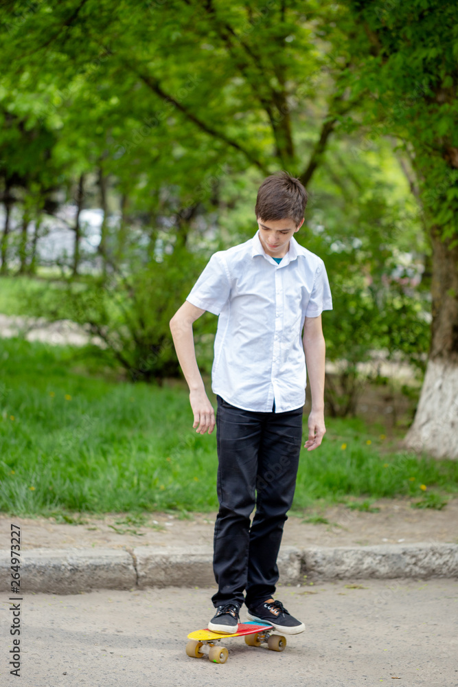 Boy Ride Skateboard in City Street. Young Teenager on Skate in Park. Urban Summer Lifestyle. Teen Skater Drive Longboard on Asphalt Boy Ride Skateboard in City Street. Young Teenager on Skate in Park. Urban Summer Lifestyle. Teen Skater Drive Longboard on Asphalt