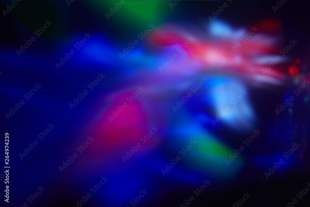 Multicolored blurred spots of light on a dark background. Multicolored blurred spots of light on a dark background.