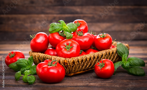 Fresh ripe tomatoes and basil in the basket